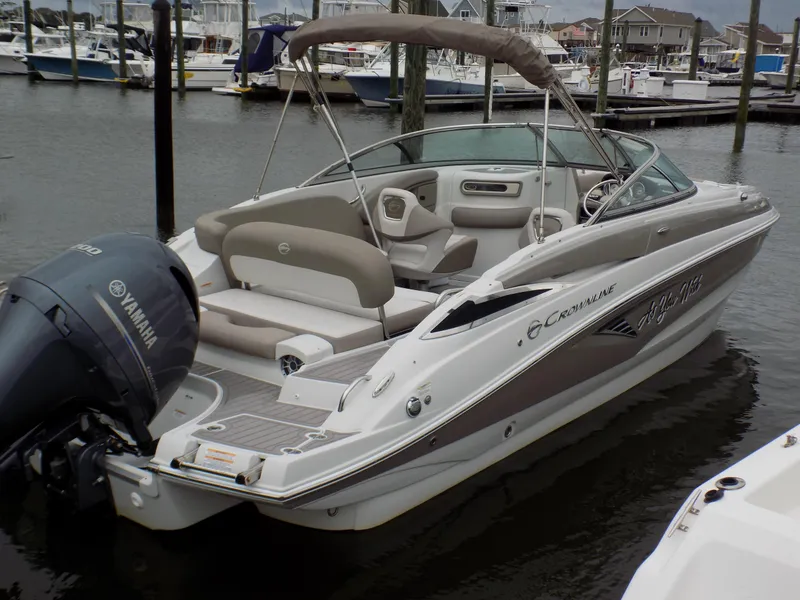 Slide: The Image of 2018 Crownline Eclipse E23 XS boat docked with Yamaha outboard motor. - 0