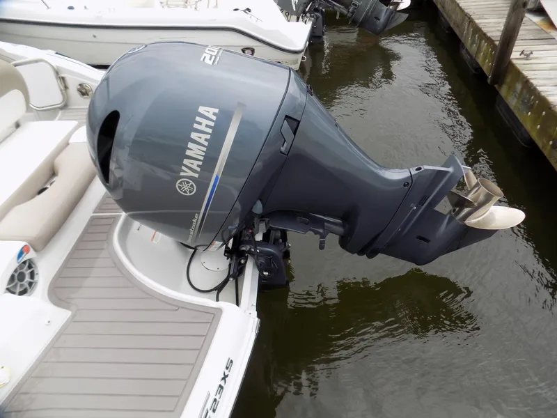 Slide: The Image of 2018 Crownline Eclipse E23 XS with Yamaha outboard motor, docked on calm water. - 12