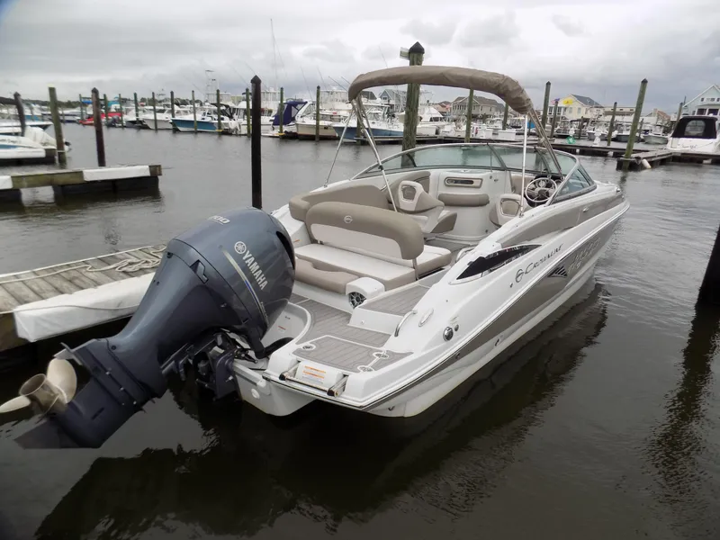 Slide: The Image of 2018 Crownline Eclipse E23 XS boat docked with Yamaha outboard motor. - 2