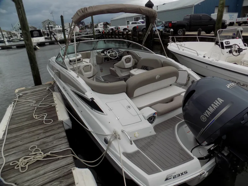 Slide: The Image of 2018 Crownline Eclipse E23 XS boat docked, featuring Yamaha outboard motor and spacious seating. - 3