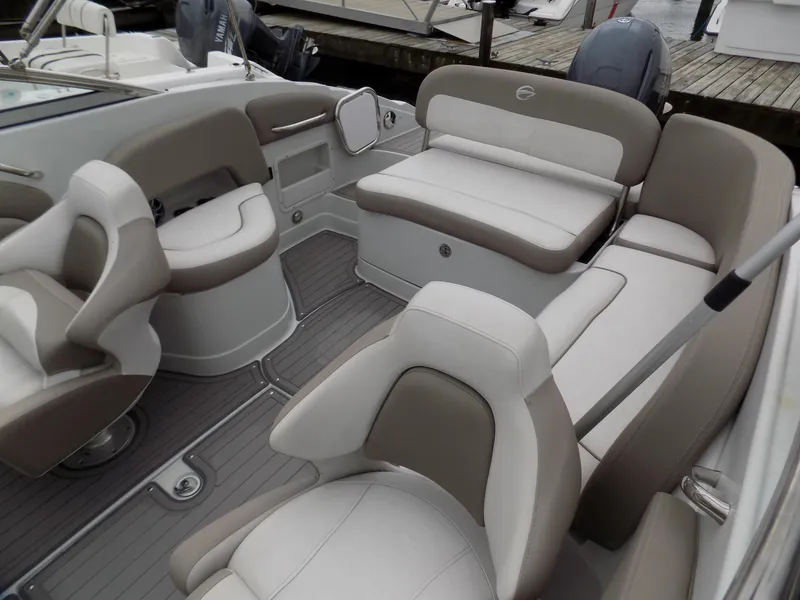 Slide: The Image of 2018 Crownline Eclipse E23 XS boat interior with beige and white seating. - 6