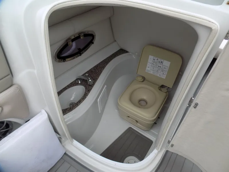 Slide: The Image of 2018 Crownline Eclipse E23 XS boat bathroom with sink and portable toilet. - 9
