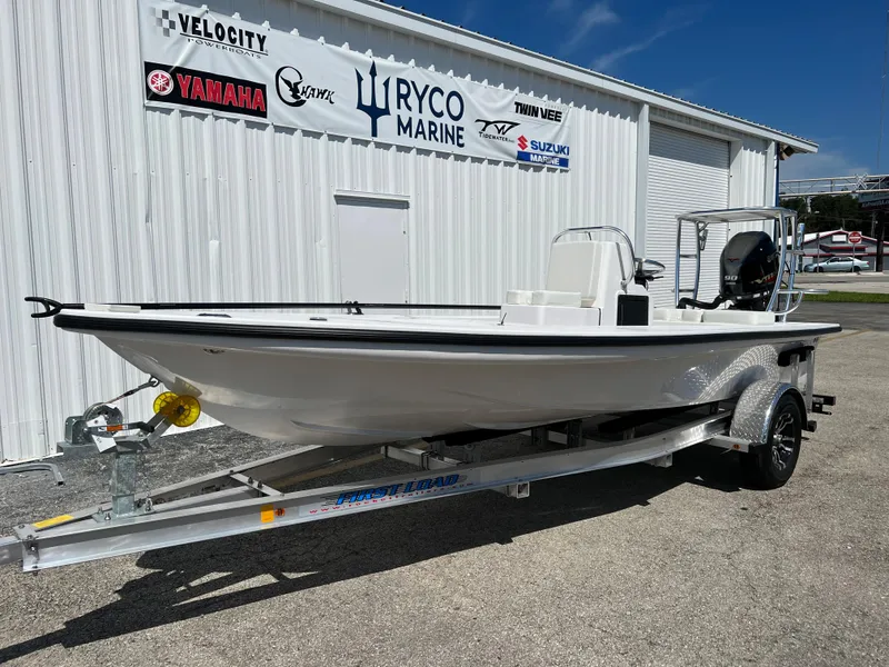 Slide: The Image of 2022 Xplor X7 boat with Yamaha outboard motor on trailer in parking lot. - 2