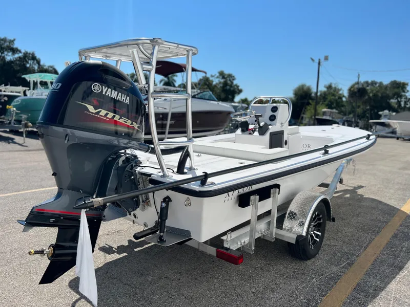 Slide: The Image of 2022 Xplor X7 boat with Yamaha 90 outboard motor in a marina. - 3