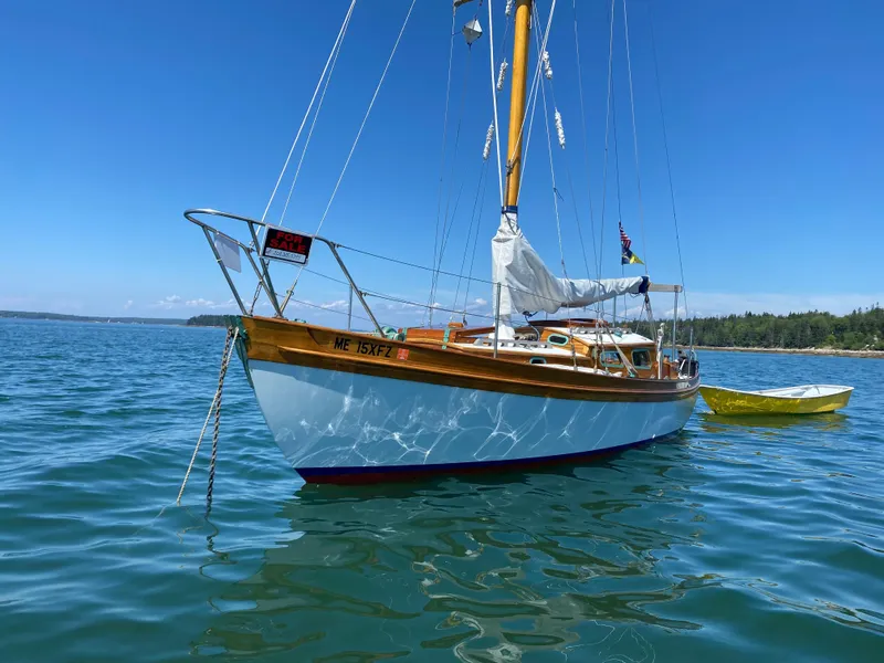 Slide: The Image of Laurent Giles Vertue Class Sloop, 2010, anchored on calm blue water under clear sky. - 1
