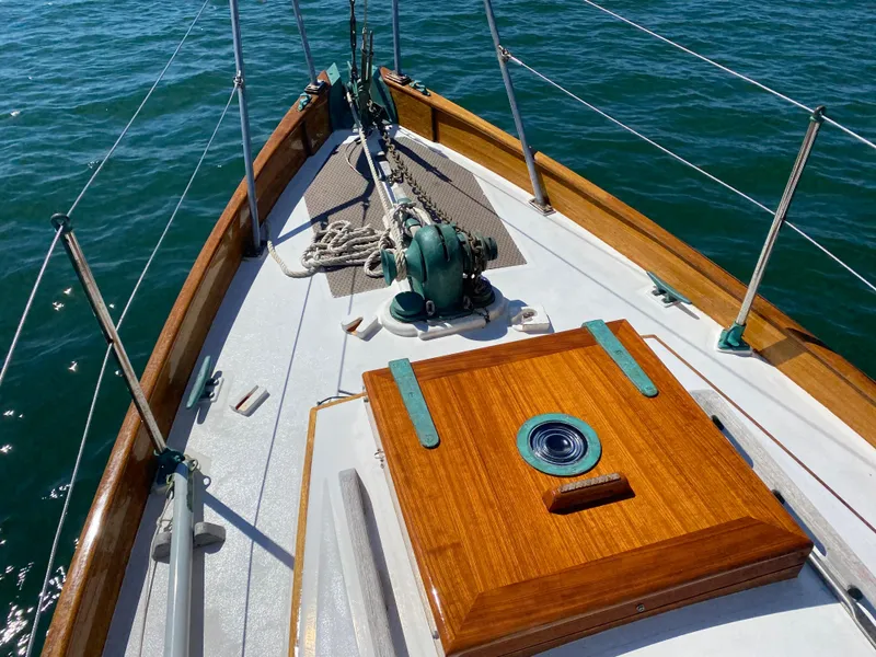 Slide: The Image of 2010 Laurent Giles Vertue Class Sloop deck with wooden details and nautical equipment. - 16
