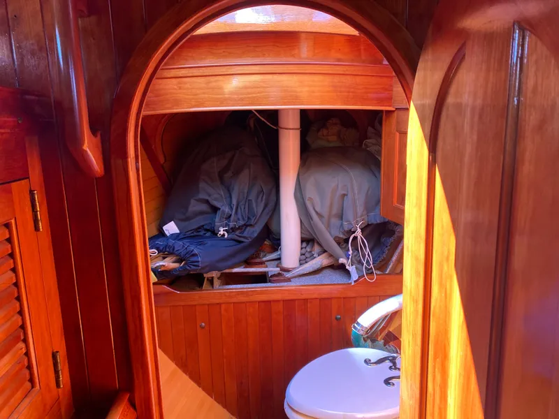 Slide: The Image of Interior of 2010 Laurent Giles Vertue Class Sloop, featuring wooden cabinetry and nautical equipment. - 21
