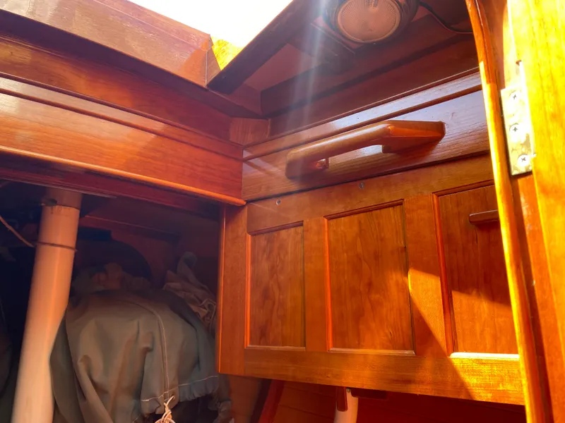 Slide: The Image of Wooden interior of a 2010 Laurent Giles Vertue Class Sloop, featuring sunlight on cabinetry. - 24
