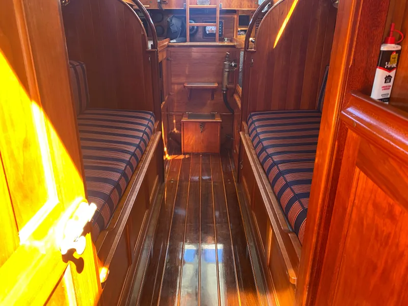 Slide: The Image of Interior of 2010 Laurent Giles Vertue Class Sloop with polished wood and striped seating. - 31