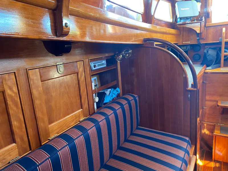 Slide: The Image of Interior of 2010 Laurent Giles Vertue Class Sloop with wooden finish and striped seating. - 32