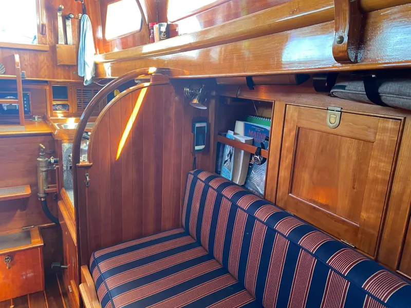 Slide: The Image of Interior of 2010 Laurent Giles Vertue Class Sloop with wooden finish and striped seating. - 33