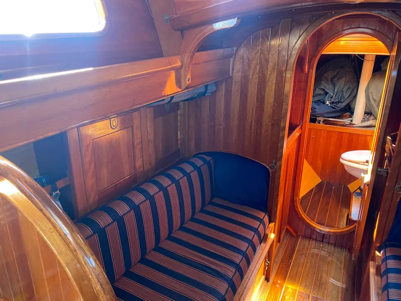 Slide: The Image of Interior of 2010 Laurent Giles Vertue Class Sloop with wooden finish and striped seating. - 35
