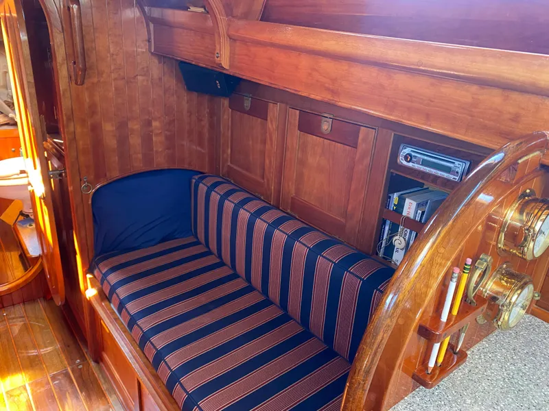 Slide: The Image of Interior of 2010 Laurent Giles Vertue Class Sloop with striped seating and wooden cabinetry. - 36