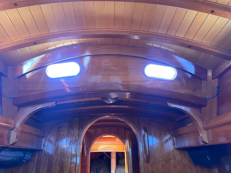 Slide: The Image of Interior of 2010 Laurent Giles Vertue Class Sloop with wooden finish and portholes. - 37