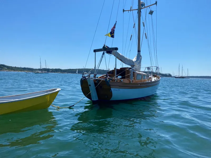 Slide: The Image of Laurent Giles Vertue Class Sloop, 2010, anchored in calm blue waters under clear sky. - 8