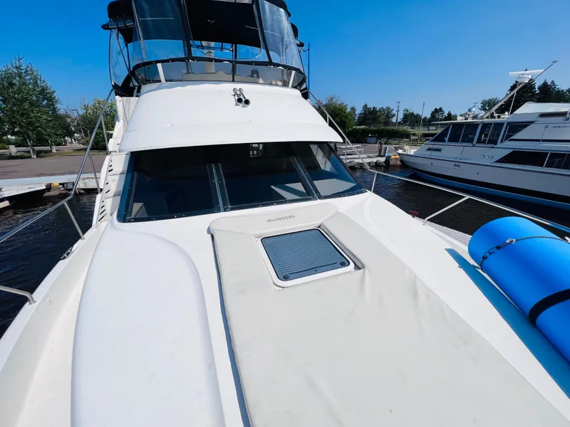 Slide: The Image of 1999 Silverton 392 Motor Yacht docked, featuring spacious deck and sleek design. - 17