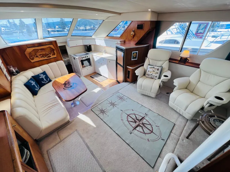 Slide: The Image of Luxurious interior of a 1999 Silverton 392 Motor Yacht with plush seating and nautical decor. - 18