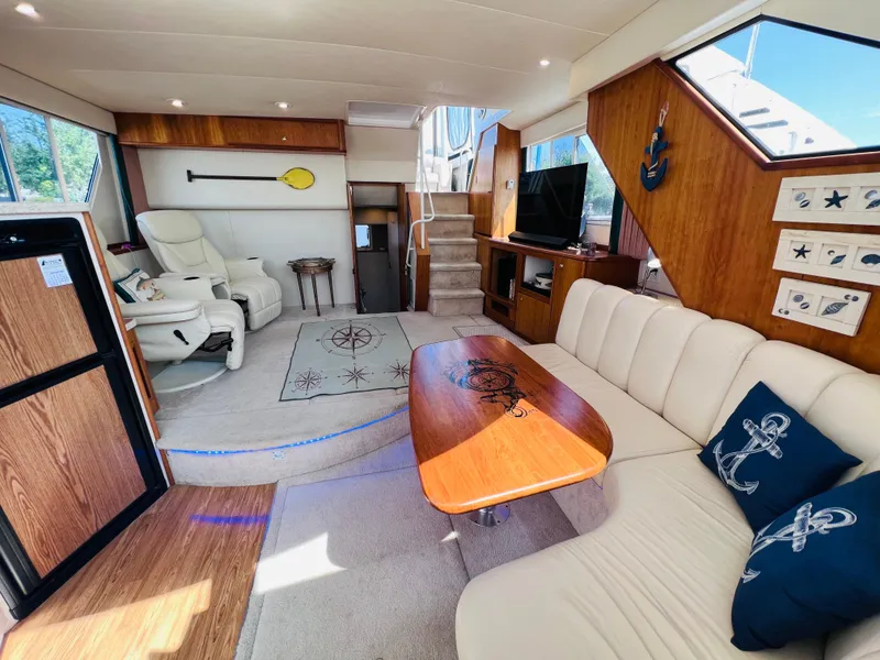 Slide: The Image of Luxurious interior of 1999 Silverton 392 Motor Yacht with elegant seating and nautical decor. - 19