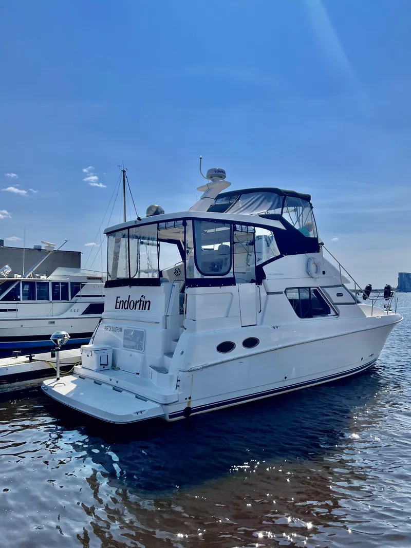 Slide: The Image of 1999 Silverton 392 Motor Yacht docked under clear blue sky. - 2