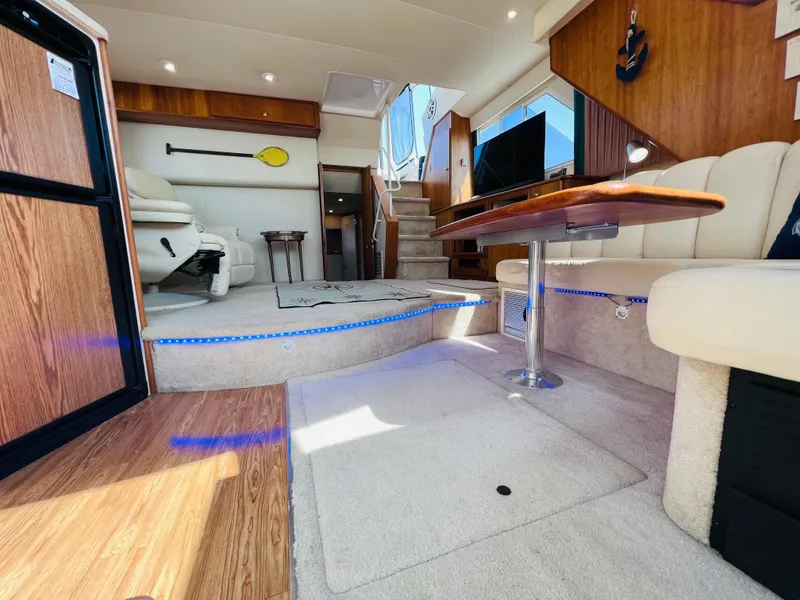 Slide: The Image of Interior of 1999 Silverton 392 Motor Yacht with modern furnishings and ambient lighting. - 20