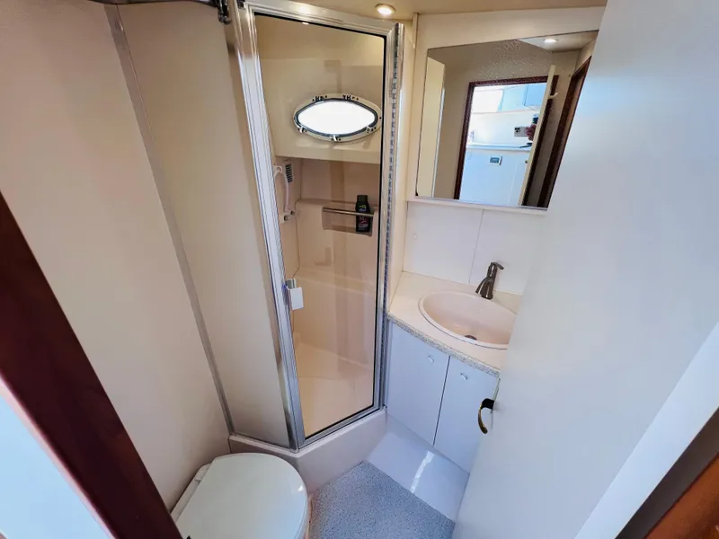 Slide: The Image of Bathroom interior of 1999 Silverton 392 Motor Yacht with shower, sink, and toilet. - 22