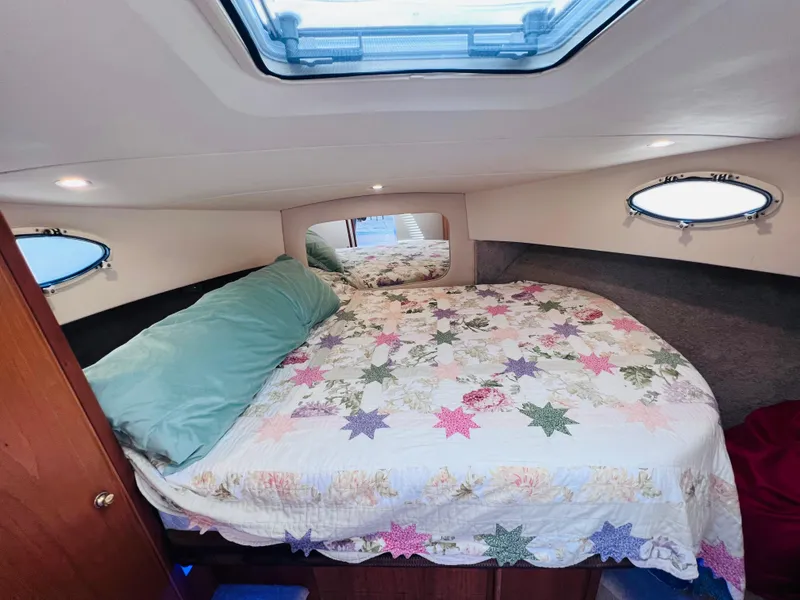 Slide: The Image of Cozy bedroom in 1999 Silverton 392 Motor Yacht with quilted bedding and skylight. - 23