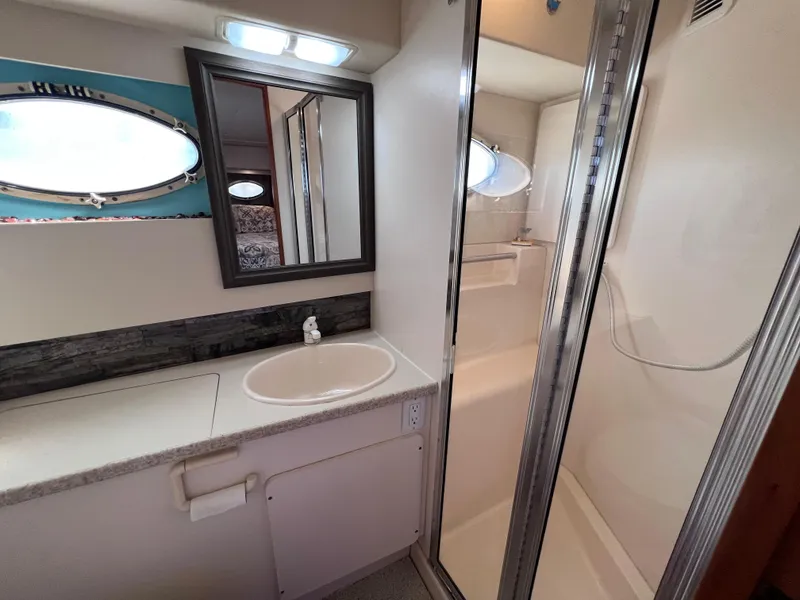 Slide: The Image of Bathroom interior of 1999 Silverton 392 Motor Yacht with sink, mirror, and shower. - 24