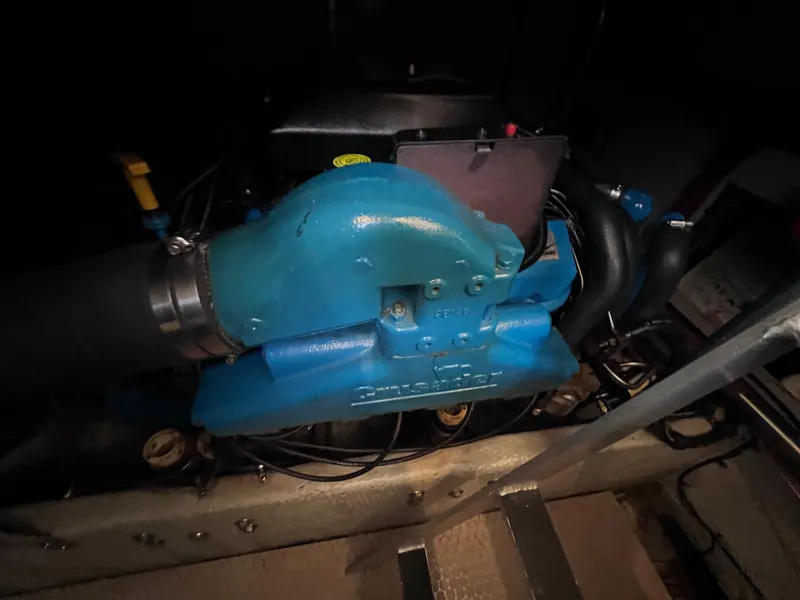 Slide: The Image of Engine compartment of a 1999 Silverton 392 Motor Yacht, featuring a blue engine component. - 27