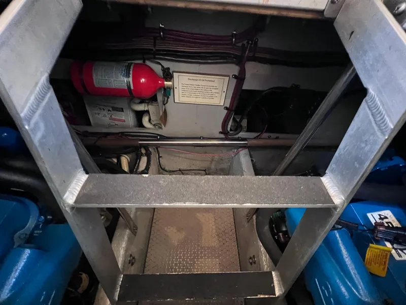 Slide: The Image of Engine room of 1999 Silverton 392 Motor Yacht with fire extinguisher and wiring. - 28