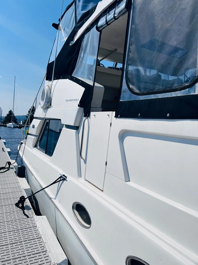 Slide: The Image of 1999 Silverton 392 Motor Yacht docked at marina under clear blue sky. - 6