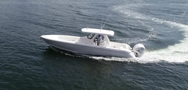 The Image of 2020 Intrepid 345 Nomad boat cruising on open water, side view. - 0