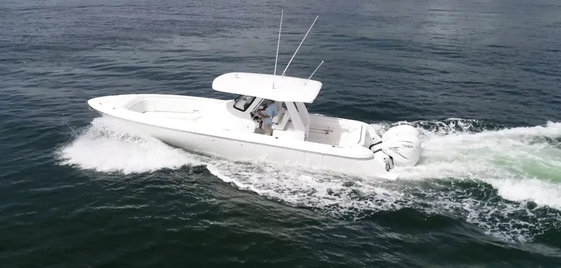 Slide: The Image of 2020 Intrepid 345 Nomad boat cruising on open water. - 16