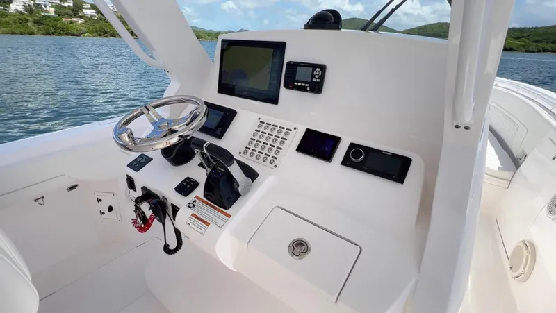 Slide: The Image of 2020 Intrepid 345 Nomad boat dashboard with steering wheel and navigation controls. - 4