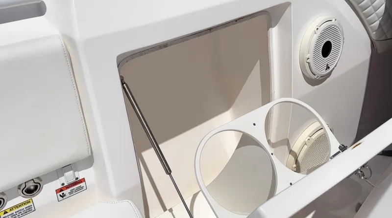 Slide: The Image of 2020 Intrepid 345 Nomad boat interior with storage compartment and cup holders. - 8