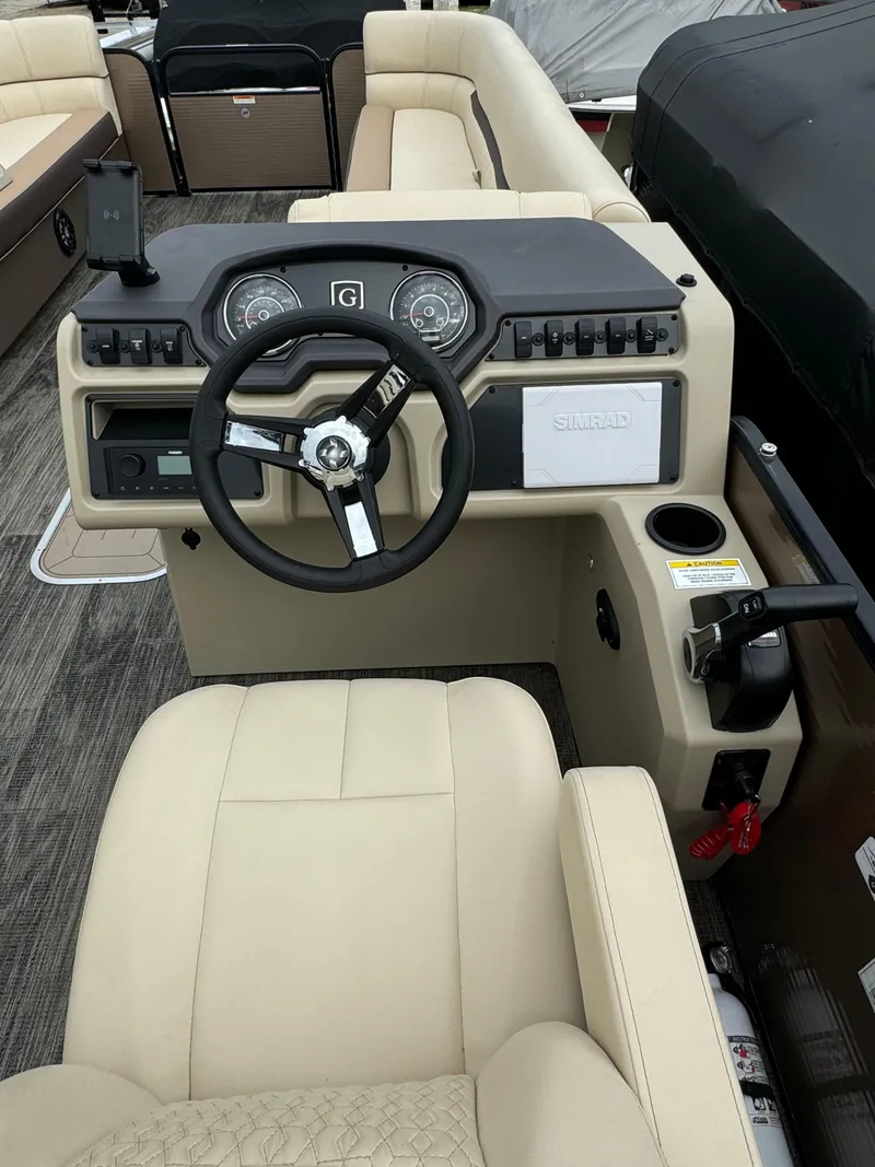 Slide: The Image of 2023 Sweetwater SW246SFL boat dashboard with steering wheel and controls. - 6