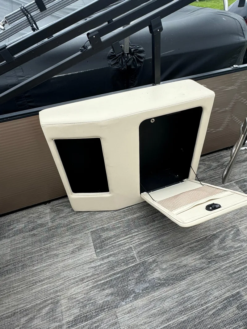 Slide: The Image of 2023 Sweetwater 2486 SFLC boat storage compartment with open hatch on deck. - 7