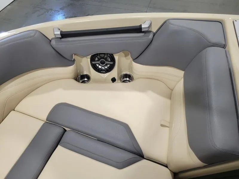 Slide: The Image of 2022 Supra SR400 boat interior with beige and gray seating, cup holders, and speaker. - 16