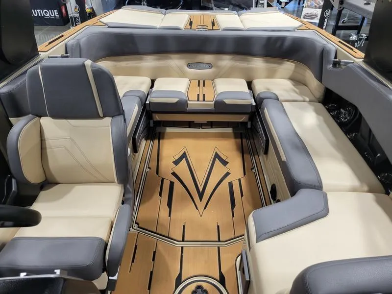 Slide: The Image of 2022 Supra SR400 boat interior with beige and gray seating, stylish wood flooring. - 19