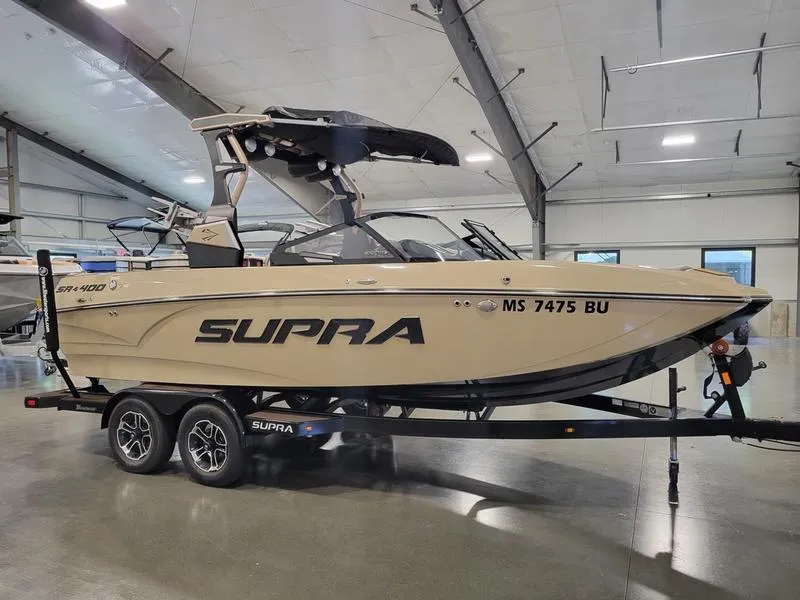 Slide: The Image of 2022 Supra SR400 boat on trailer in indoor storage facility. - 2
