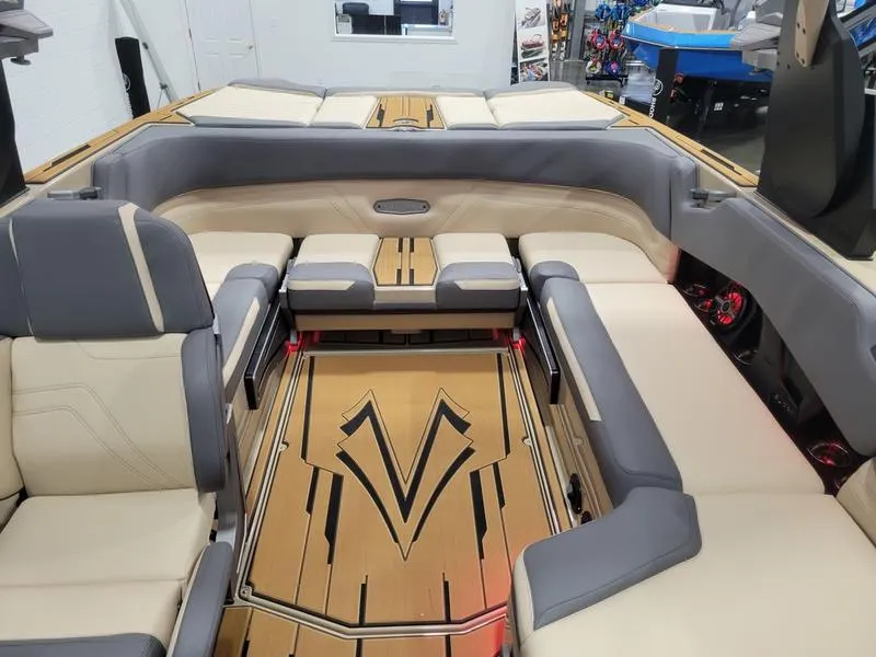 Slide: The Image of 2022 Supra SR400 boat interior with luxurious seating and stylish wood flooring. - 22