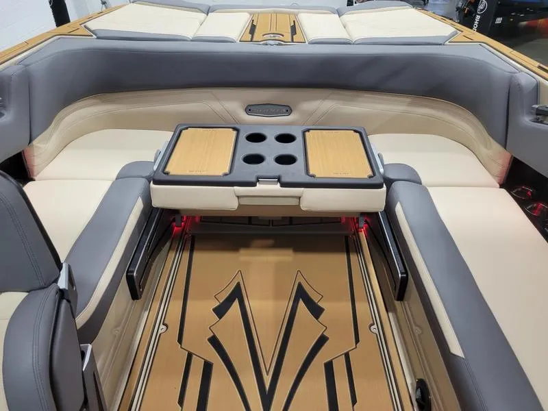 Slide: The Image of 2022 Supra SR400 boat interior with beige and gray seating, foldable table, and stylish flooring. - 25