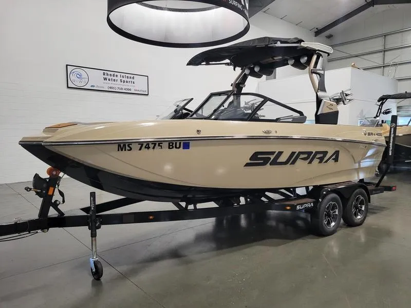Slide: The Image of 2022 Supra SR400 boat on trailer in showroom. - 3