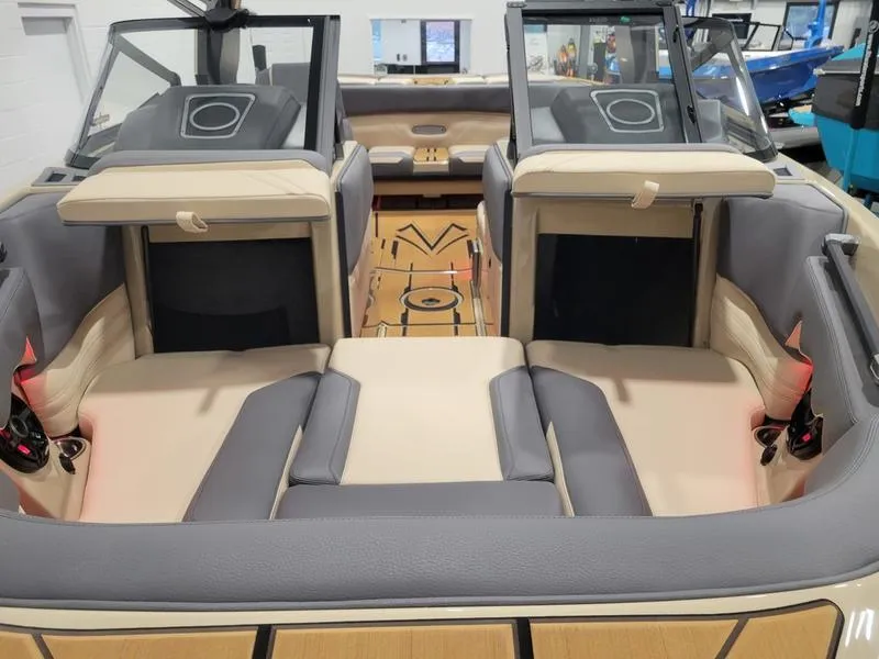Slide: The Image of 2022 Supra SR400 boat interior with beige and gray seating, open bow, and modern design. - 30