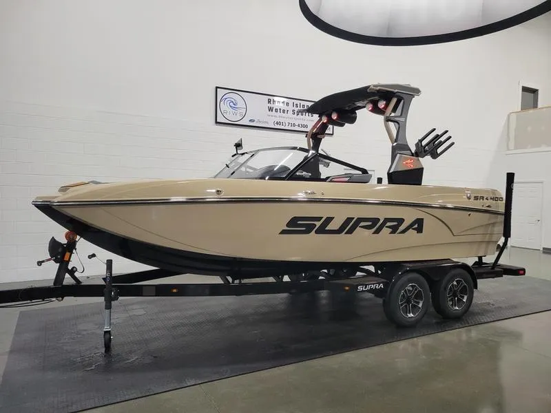 Slide: The Image of 2022 Supra SR400 boat on trailer in showroom. - 31