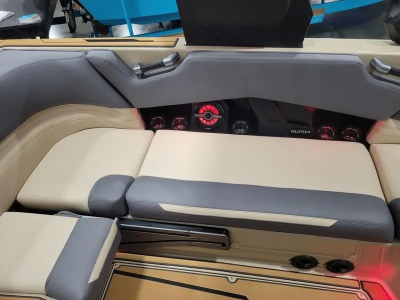 Slide: The Image of 2022 Supra SR400 boat interior with beige and gray seating, modern dashboard. - 32
