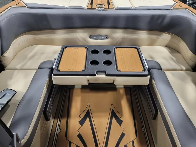 Slide: The Image of 2022 Supra SR400 boat interior with beige and gray seating, and a foldable table. - 33