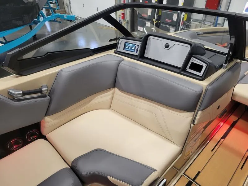 Slide: The Image of Interior of a 2022 Supra SR400 boat with beige and gray seating. - 35