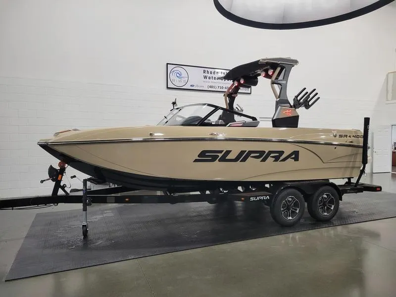 Slide: The Image of 2022 Supra SR400 boat on trailer in showroom. - 36