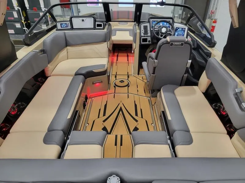 Slide: The Image of 2022 Supra SR400 boat interior with beige and gray seating, modern dashboard, and ambient lighting. - 38