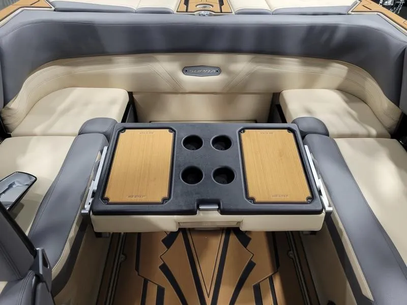 Slide: The Image of 2022 Supra SR400 boat interior with beige and gray seating, and a central table with cup holders. - 41